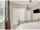 The bedroom includes closet and exterior doors, along with a TV at 7428 Alamo Ranch Ave, Las Vegas, NV 89179