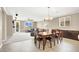 This dining room features a wooden table set beneath a chandelier and a view of the living room at 7428 Alamo Ranch Ave, Las Vegas, NV 89179