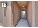 A welcoming front door with a decorative light fixture and textured walls at 7428 Alamo Ranch Ave, Las Vegas, NV 89179