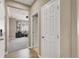 Hallway leading to a bright home office with neutral walls, carpet floors, and a ceiling fan at 7428 Alamo Ranch Ave, Las Vegas, NV 89179