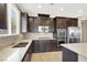 Well-equipped kitchen with dark cabinets, granite countertops, and stainless steel appliances at 7428 Alamo Ranch Ave, Las Vegas, NV 89179