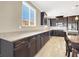 Kitchen with expansive countertop space, dark wood cabinets, and stainless steel appliances at 7428 Alamo Ranch Ave, Las Vegas, NV 89179