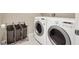 Convenient laundry room equipped with modern washer and dryer, with a laundry hamper and ample space for chores at 7428 Alamo Ranch Ave, Las Vegas, NV 89179