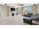 This living room features a fireplace, a television, and a comfortable gray couch at 7428 Alamo Ranch Ave, Las Vegas, NV 89179