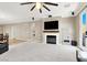 Open-concept living room showcasing a fireplace, television, and adjoining dining area and laundry room at 7428 Alamo Ranch Ave, Las Vegas, NV 89179