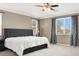 This primary bedroom features large windows, neutral walls, and carpeted floors at 7428 Alamo Ranch Ave, Las Vegas, NV 89179