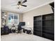 Functional home office with a glass top desk, office chair, and ample shelving for storage and display at 7428 Alamo Ranch Ave, Las Vegas, NV 89179