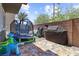 Entertaining backyard featuring a trampoline, toys, and outdoor cooking area at 7515 Emerald Stars St # 102, North Las Vegas, NV 89084