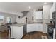 Open kitchen with island, granite countertops and stainless steel appliances at 7515 Emerald Stars St # 102, North Las Vegas, NV 89084