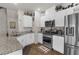 Well-lit kitchen featuring stainless steel appliances, granite countertops, and modern decor at 7515 Emerald Stars St # 102, North Las Vegas, NV 89084