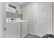 Well-lit laundry room featuring a white washer and dryer set with shelving and decor accents at 7515 Emerald Stars St # 102, North Las Vegas, NV 89084