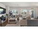 Bright living room with large windows, a comfortable sectional sofa, and modern decor at 7515 Emerald Stars St # 102, North Las Vegas, NV 89084