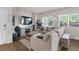 Inviting living room featuring large windows and a plush sectional sofa at 7515 Emerald Stars St # 102, North Las Vegas, NV 89084