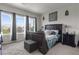 Inviting main bedroom with ample natural light, tasteful decor, and a comfortable bed at 7515 Emerald Stars St # 102, North Las Vegas, NV 89084