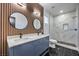 A stylish bathroom featuring a double vanity, elegant mirrors, and a luxurious, tiled walk-in shower at 7849 Montour Falls St, Las Vegas, NV 89149