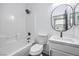 A modern bathroom with a combination tub and shower, sleek fixtures, and ample counter space at 7849 Montour Falls St, Las Vegas, NV 89149