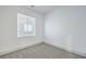 Bright bedroom with neutral carpet, white walls, and a window with blinds allowing for natural light at 7849 Montour Falls St, Las Vegas, NV 89149