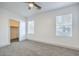 Sunlit bedroom with cozy carpet, two windows, and a walk-in closet for ample storage at 7849 Montour Falls St, Las Vegas, NV 89149