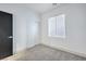 A bright bedroom is freshly painted with plush carpeting and a large, light-filled window at 7849 Montour Falls St, Las Vegas, NV 89149