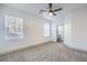 A spacious and light-filled bedroom that includes plush carpeting, two windows, en-suite bath, and ample space at 7849 Montour Falls St, Las Vegas, NV 89149