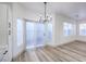 Bright dining area with wood-look flooring, sliding glass door, and chandelier at 7849 Montour Falls St, Las Vegas, NV 89149