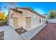 Side view of house with a two car garage, desert landscaping and tiled roof at 7849 Montour Falls St, Las Vegas, NV 89149