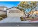 Single-story home with an attached two-car garage and desert landscaping at 7849 Montour Falls St, Las Vegas, NV 89149