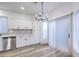Modern kitchen with stainless steel appliances, white cabinets, and a sliding glass door at 7849 Montour Falls St, Las Vegas, NV 89149