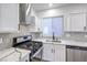 Bright kitchen boasts stainless steel appliances, countertops, and a stylish backsplash at 7849 Montour Falls St, Las Vegas, NV 89149
