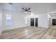 Open living room featuring modern wood-look flooring, ceiling fan and neutral walls at 7849 Montour Falls St, Las Vegas, NV 89149