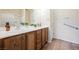 Bathroom featuring a double vanity with wood cabinets and a large mirror at 7957 Fantail Dr, North Las Vegas, NV 89084