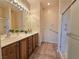 Well-lit bathroom featuring a double vanity with a shower and tile flooring at 7957 Fantail Dr, North Las Vegas, NV 89084