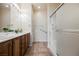 Bathroom featuring a double vanity with wood cabinets and a glass-enclosed shower at 7957 Fantail Dr, North Las Vegas, NV 89084