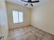 A bright bedroom features neutral walls and a window with plantation shutters at 7957 Fantail Dr, North Las Vegas, NV 89084
