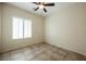 Bedroom with ceiling fan, tile floors, and plantation shutters for ample light control at 7957 Fantail Dr, North Las Vegas, NV 89084
