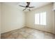 Bedroom with tile flooring, natural light and a ceiling fan, ideal for comfort at 7957 Fantail Dr, North Las Vegas, NV 89084