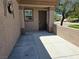 Inviting front entrance featuring a secure brown door and a charming exterior design with stucco and a small window at 7957 Fantail Dr, North Las Vegas, NV 89084