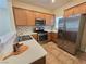 Kitchen with stainless steel appliances, light wood cabinets, and a decorative backsplash at 7957 Fantail Dr, North Las Vegas, NV 89084