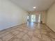 Open living room featuring tile floors and sliding door to the backyard at 7957 Fantail Dr, North Las Vegas, NV 89084