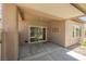 Cozy covered patio with concrete flooring and access to the backyard through sliding glass doors at 7957 Fantail Dr, North Las Vegas, NV 89084