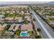 Aerial shot of a neighborhood featuring well-manicured lawns, mature trees, and a sparkling pool in the backyard at 8356 Shady Lady Ct, Las Vegas, NV 89131