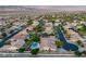 Expansive aerial view of a quiet neighborhood featuring lush landscaping and private pools with a mountain view backdrop at 8356 Shady Lady Ct, Las Vegas, NV 89131