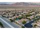 Drone view of a residential area with pools, landscaping, and mountain views at 8356 Shady Lady Ct, Las Vegas, NV 89131