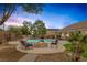 Backyard featuring a pool, fire pit, landscaped areas, and comfortable lounge chairs at 8356 Shady Lady Ct, Las Vegas, NV 89131