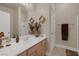 Well-lit bathroom featuring a granite countertop, decorative vases, and neutral wall color at 8356 Shady Lady Ct, Las Vegas, NV 89131