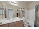 Bright bathroom with a shower-tub combo, white cabinets, and decorated shelves at 8356 Shady Lady Ct, Las Vegas, NV 89131