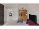 Well-lit bedroom with a large television, built-in shelving, and carpet flooring at 8356 Shady Lady Ct, Las Vegas, NV 89131