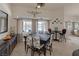 Dining area with view of pool through large windows, tile floors and table with chairs at 8356 Shady Lady Ct, Las Vegas, NV 89131