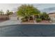 Inviting home exterior featuring mature landscaping, a spacious driveway, and a three-car garage at 8356 Shady Lady Ct, Las Vegas, NV 89131