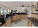 Open kitchen boasts granite counters, wood cabinets, and modern appliances at 8356 Shady Lady Ct, Las Vegas, NV 89131